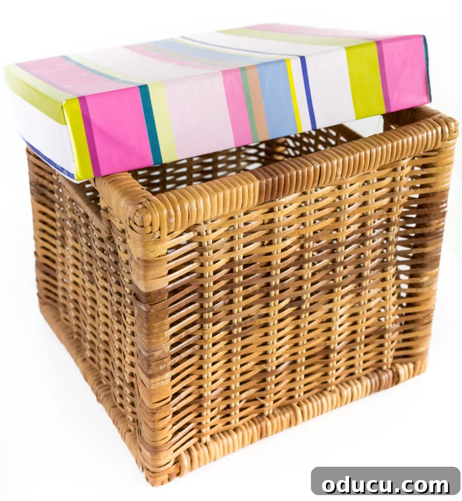 Instant Summer Room Makeover 7 A square woven basket with a colorful DIY lid made from cardboard and fabric, showcasing a decorative basket idea for storage.