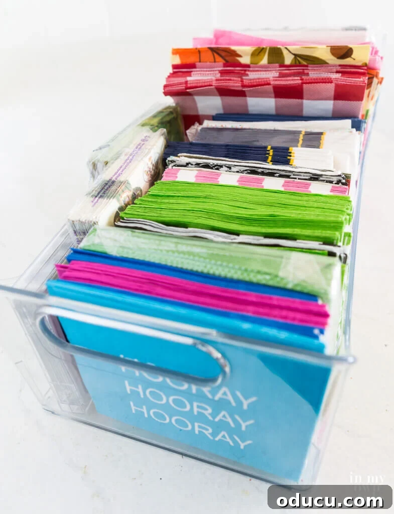 The Art of Decorating with Paper Napkins 2 A vibrant collection of patterned paper napkins neatly organized in a long bin, ready for crafting.