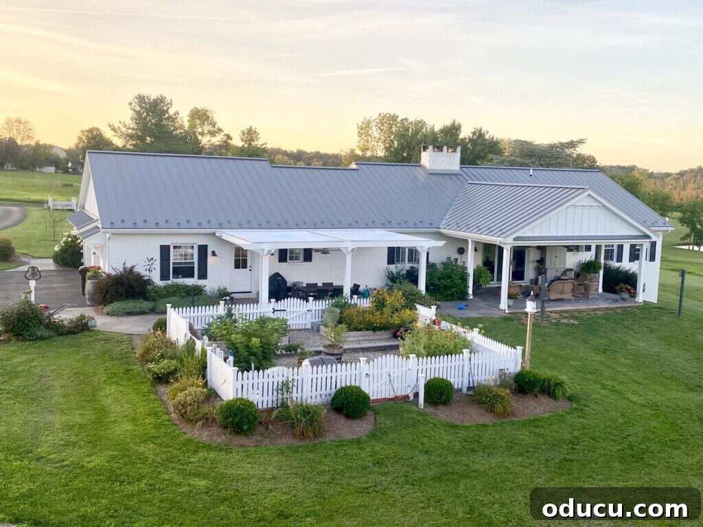 Ranch Renaissance: Modern Farmhouse Transformation 14 Backyard-after-from-above with white house, pergola, and garden