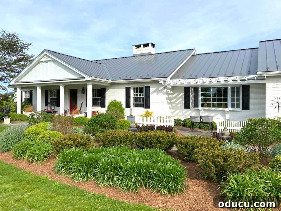 Ranch Renaissance: Modern Farmhouse Transformation 21 front-of-house-AFTER with new metal roof and established landscaping