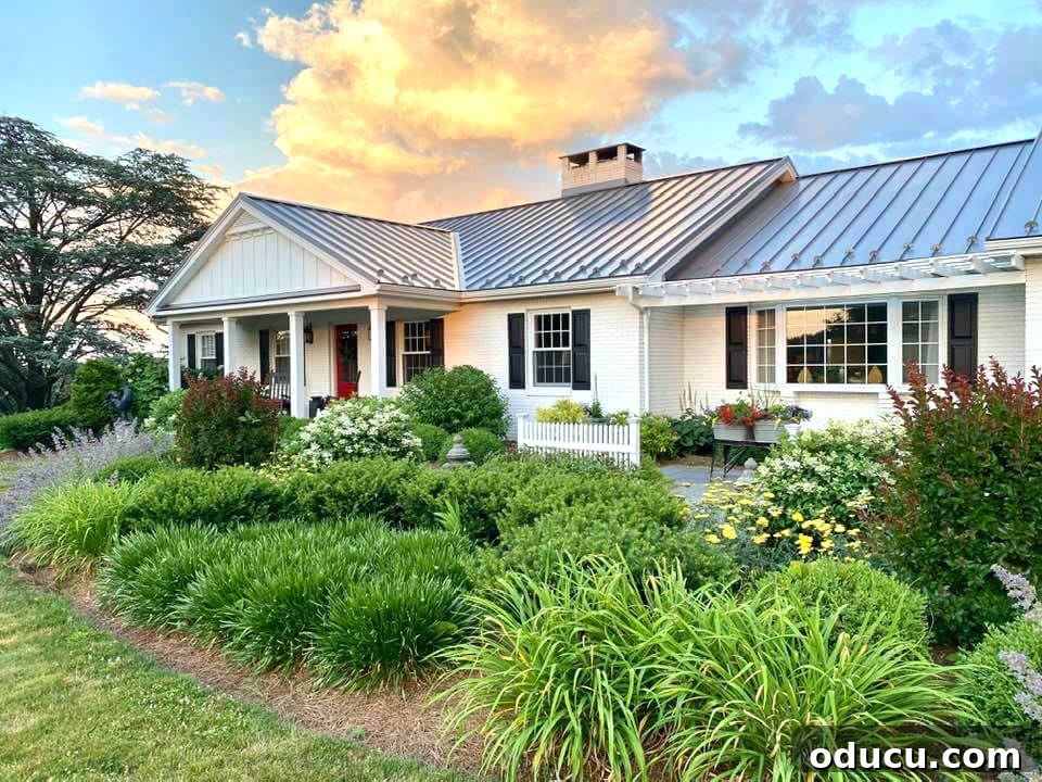 Ranch Renaissance: Modern Farmhouse Transformation 7 House front exterior after makeover with white paint and new landscaping