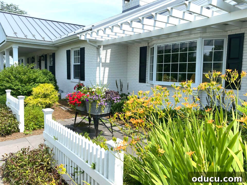 Ranch Renaissance: Modern Farmhouse Transformation 9 Back of ranch house after makeover. Painted white, pergola added and slate walkway.