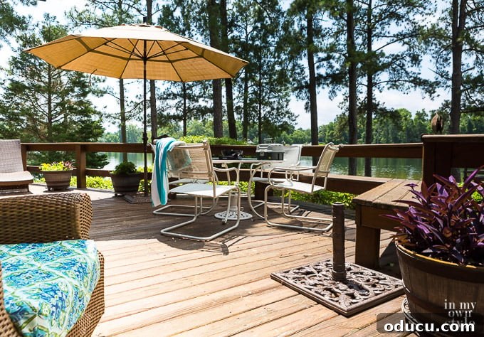 Score Free Fabric for Stunning Home Decor 2 Outdoor wood deck with a patio umbrella in a metal stand, showcasing a sturdy outdoor setup.