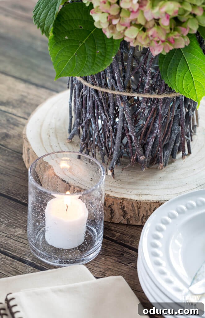 Score Free Fabric for Stunning Home Decor 12 Dining table beautifully decorated for fall, featuring a DIY twig vase and a seeded glass candle holder for warmth.