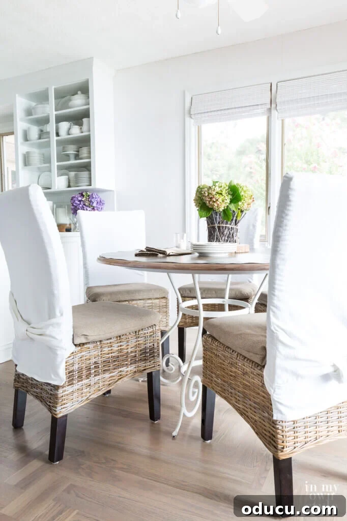 Score Free Fabric for Stunning Home Decor 13 Kitchen dining table and chairs with new neutral cushion covers on chairs, crafted from repurposed fabric of a broken patio umbrella.