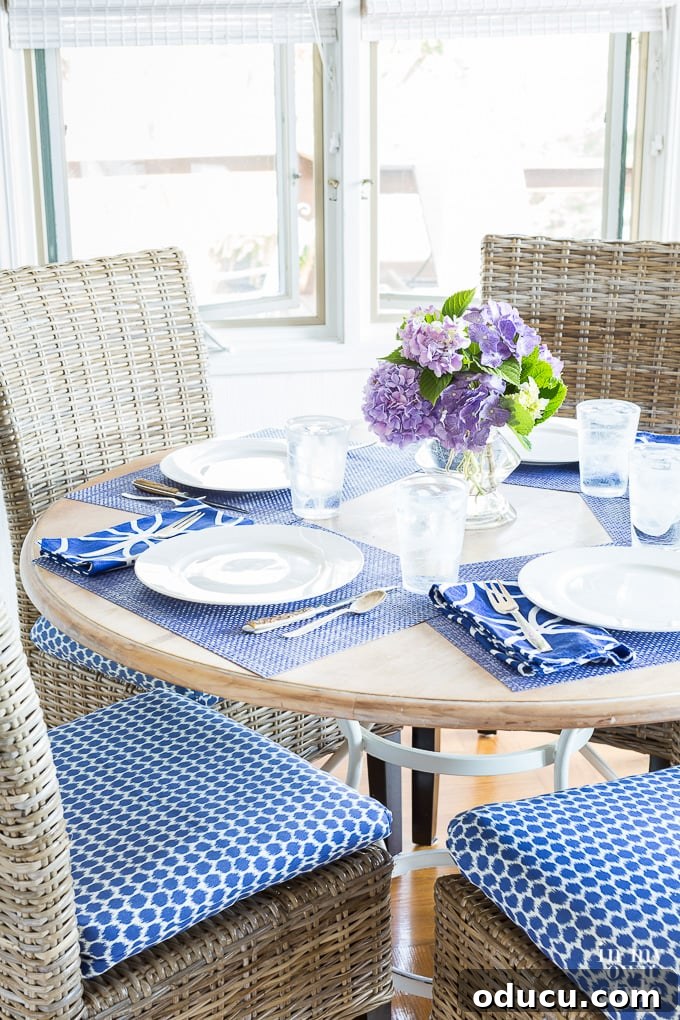 Score Free Fabric for Stunning Home Decor 4 Dining table and chairs featuring blue and white patterned chair seat cushions, bright and inviting.