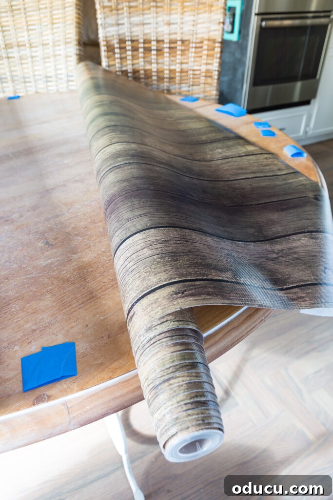 Score Free Fabric for Stunning Home Decor 10 Instructions on how to cut and size bulletin board paper to create an alternative, wood-look tablecloth.