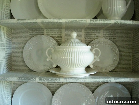 Upcycle Household Items for Breathtaking Decor 6 Decorating with common household items as done in this Dining room hutch that was decorated with pages from old books.