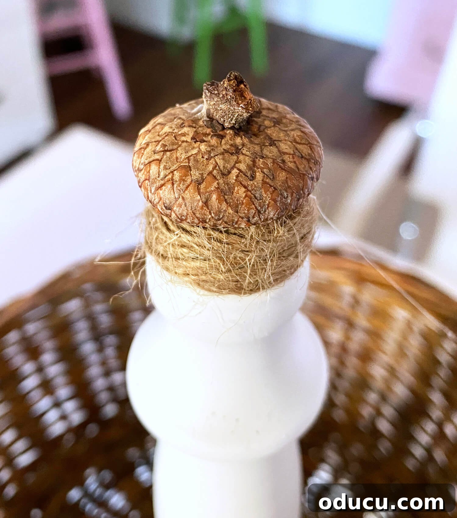 Crafting a Dual-Level Kitchen Storage Stand 11 Top of real acorn found in nature made into a decorative fall finial for a 2 tiered countertop fruit basket. A close-up of an acorn cap glued to the twine-wrapped finial.