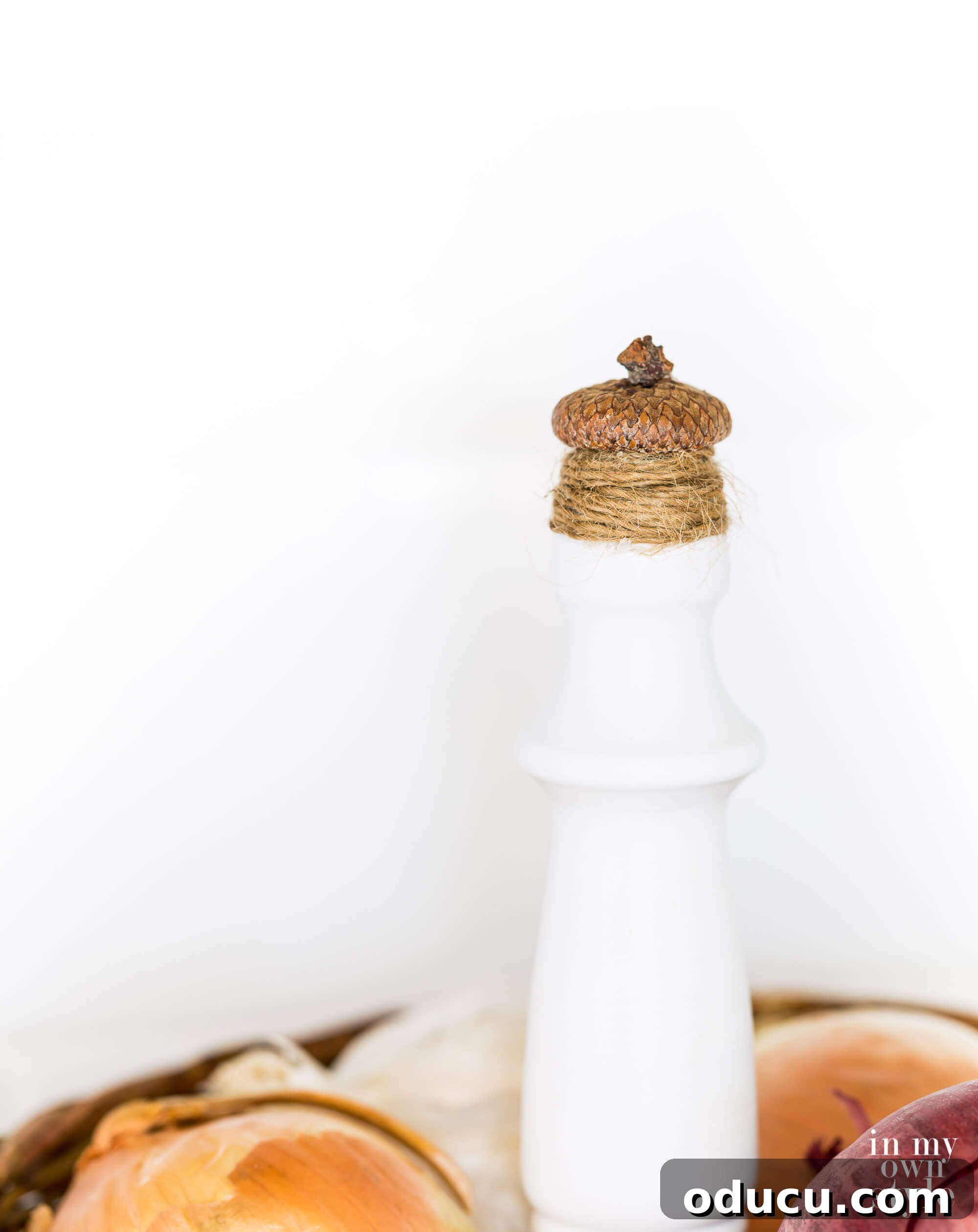Crafting a Dual-Level Kitchen Storage Stand 12 Close up of finished acorn and twine finial on top of a 2 tiered countertop fruit basket. A detailed view of the unique acorn and twine finial on the completed 2-tier stand.