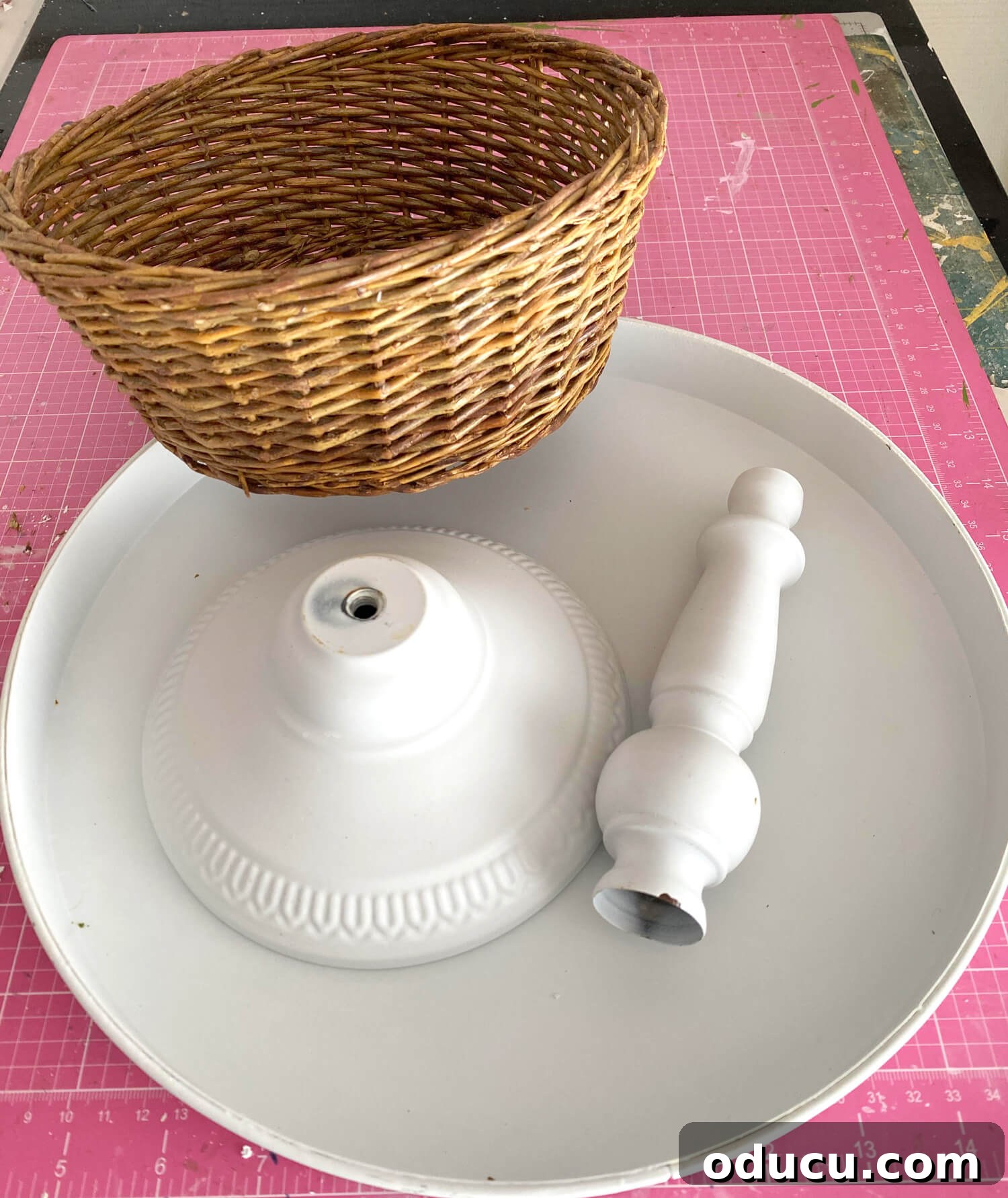 Crafting a Dual-Level Kitchen Storage Stand 6 One section of 3 tiered kitchen stand with base, rod and a round wicker basket. The disassembled components of a tiered stand and a wicker basket.