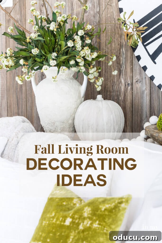 Fashion Finds Edition 18 4 Fall living room decor featuring a stone vase and pumpkin on a sofa table, with faux barn wood paneling.