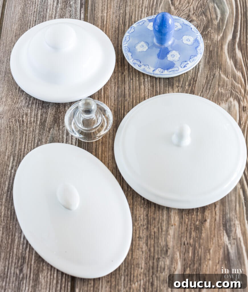 A charming selection of ceramic and glass jar lids, all featuring distinct knobs, arranged on a surface, ready to be repurposed into unique photo holders.