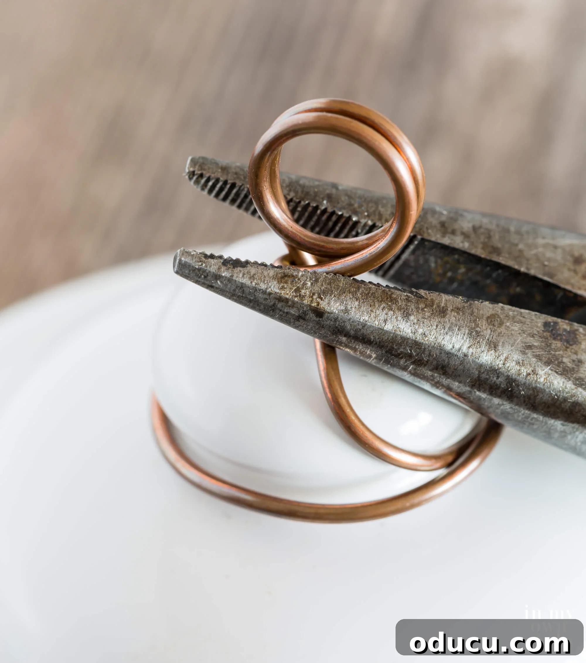 Clear instructions on how to bend and position the wire loops upright on the lid's knob, preparing them to securely hold a photo.
