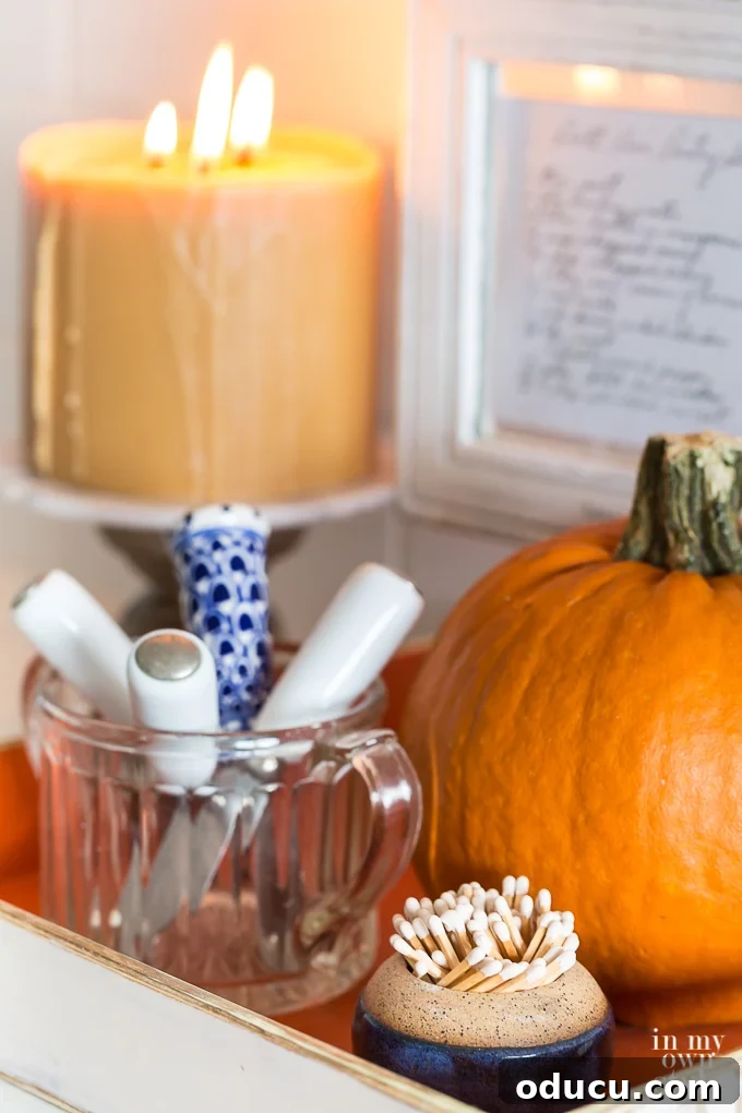 A fall candle in a kitchen setting, adding a warm glow.