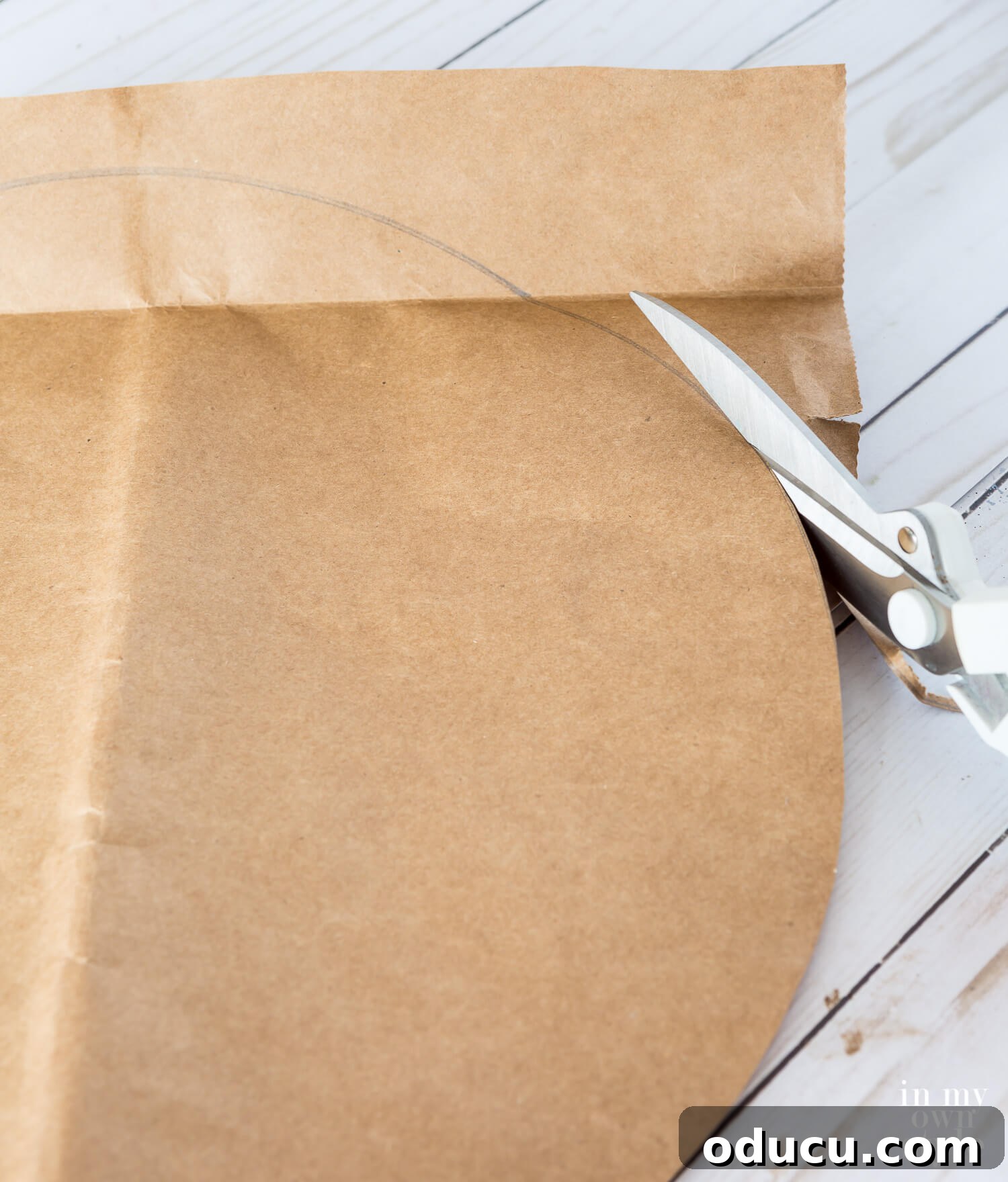Thanksgiving Table Crafts: Free Placemats and Napkin Rings 8 Cutting a large circle from a brown paper grocery bag.