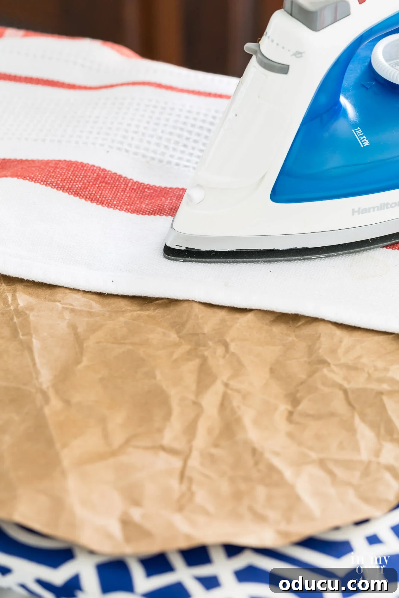 Thanksgiving Table Crafts: Free Placemats and Napkin Rings 10 Ironing a brown paper bag using a pressing cloth.