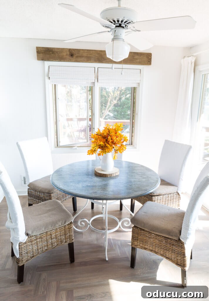 Zinc Effect Wooden Table Surfaces 23 A full view of the kitchen table with its new faux zinc finish, styled with minimal decor. The image emphasizes the overall impact of the aged metal look on the dining area, showcasing a complete DIY furniture makeover.