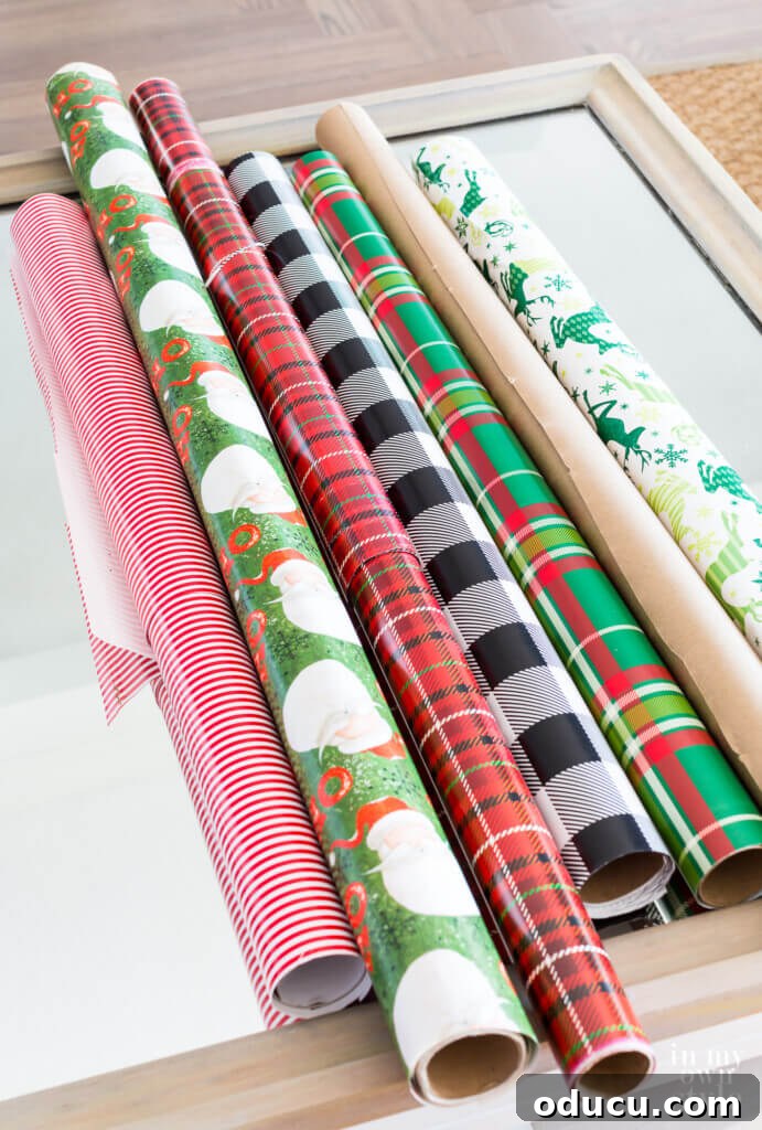 Cozy & Chic Christmas Coffee Table on a Budget 2 Various rolls of Christmas gift wrap displayed on a table, ready for decorating