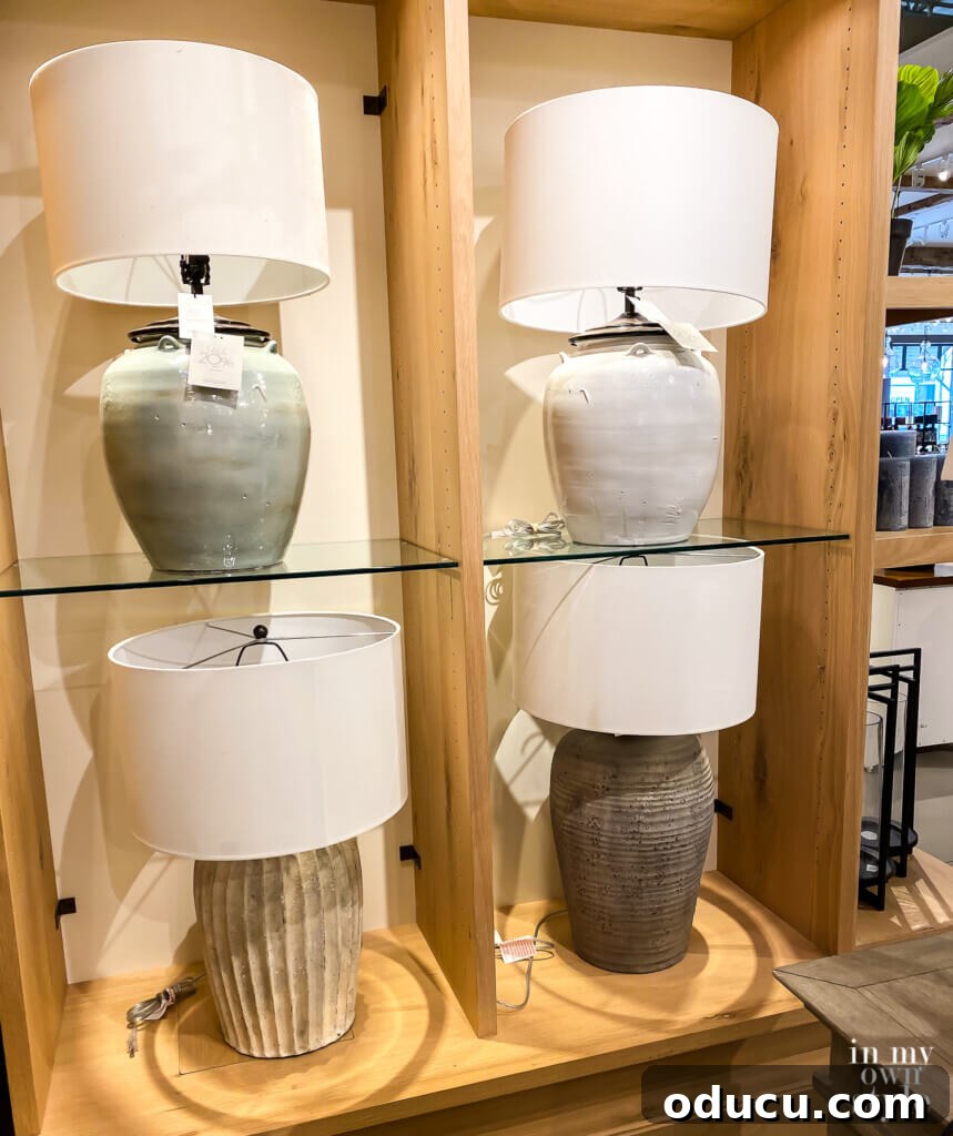 Thrifted Lamp Glow Up 2 Four stylish table lamps on display at a Pottery Barn store, showcasing modern, handcrafted earthenware designs. Perfect inspiration for a DIY lamp makeover.