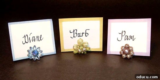 Effortless Thanksgiving Place Card Ideas for a Memorable Table 10 Creative place card holder utilizing a vintage clip-on earring to hold a name card, adding unique flair to a table setting.