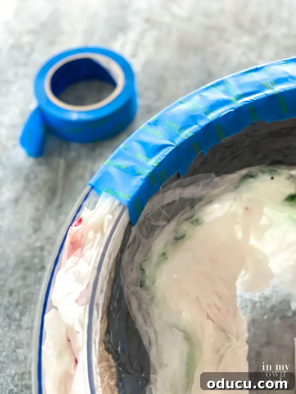 Applying painter's tape around the top edge to connect both bowls, creating the illusion of a single thick outer bowl.