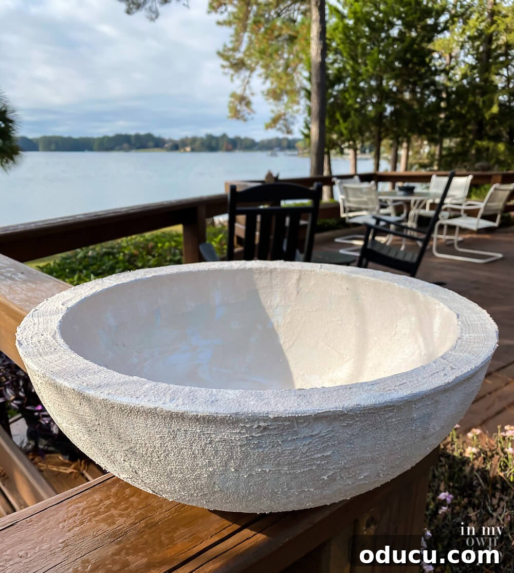 The bowl is drying outside after receiving its second layer of stucco patch, building up the faux concrete texture.