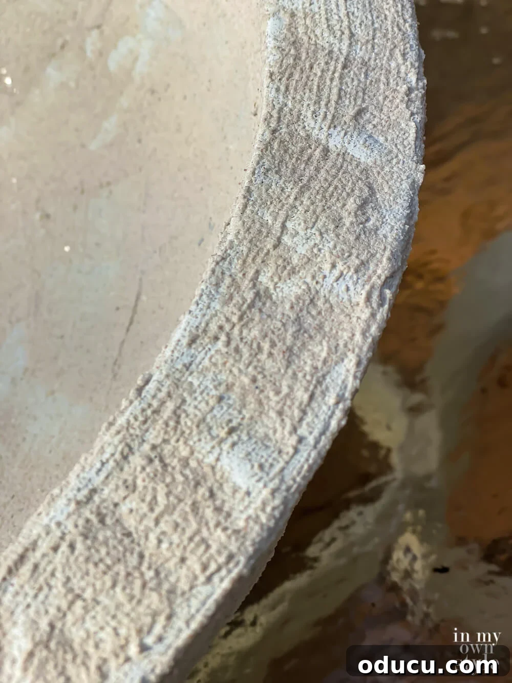 Close-up of the painted Cobblestone layer on the edge of the bowl, showcasing the nuanced faux stone finish.