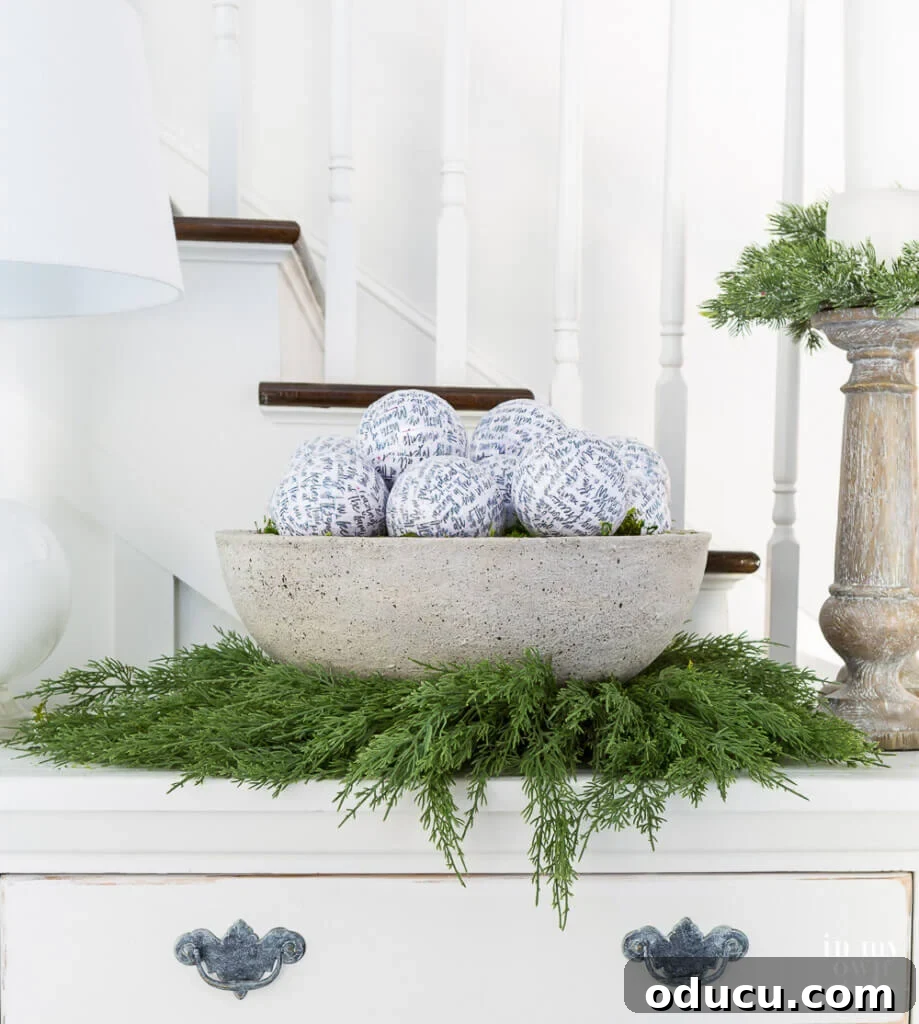 Low Zen bowl style planter on a sideboard, beautifully decorated with white and green elements for Christmas.