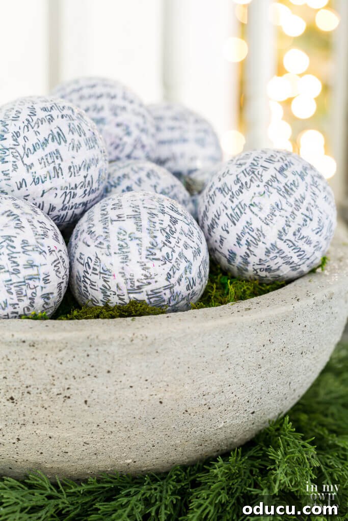 DIY faux large cast stone planter bowl filled with sparkling white glittered Christmas ornaments, showcasing holiday decor.