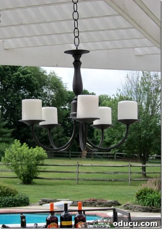 Step-by-step guide to making an outdoor candle chandelier from a thrift store light fixture. This DIY project is easy and transforms a brass chandelier into beautiful patio lighting.
