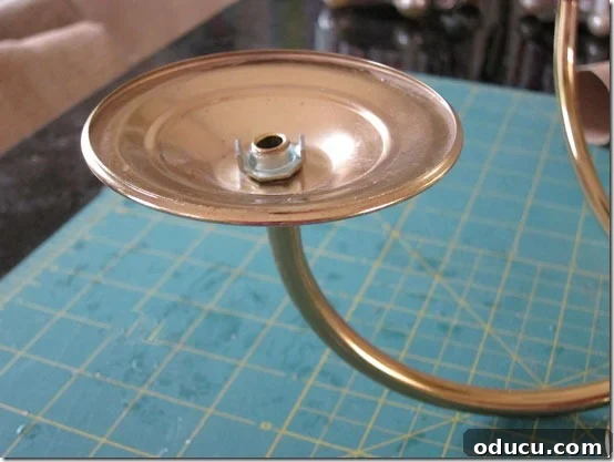 A transformed chandelier arm's candle base, now ready for painting and outdoor use.