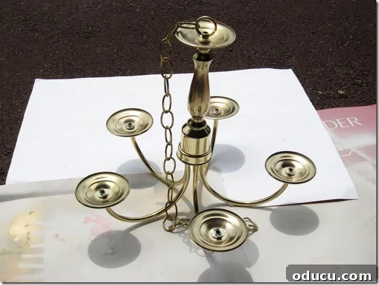 Visual guide on how to transform a basic thrift store brass chandelier into a high-end-looking outdoor candle chandelier.