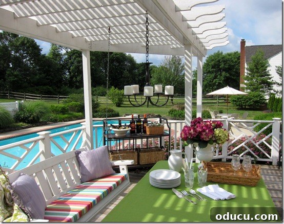 Outdoor deck scene set up for a gathering, featuring a handmade DIY hanging candle chandelier that adds ambiance.