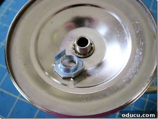 Close-up of candle base screws, demonstrating how to secure them after transforming a thrift store chandelier into outdoor lighting.