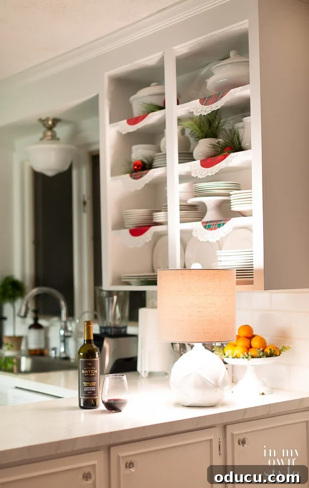 Small kitchen with a small lamp on counter to provide a cozy feel.