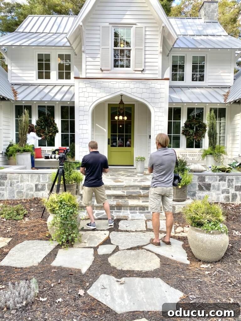 Photographer and stylist Emily A. Clark outside the beautifully decorated Southern Living Idea House entrance.