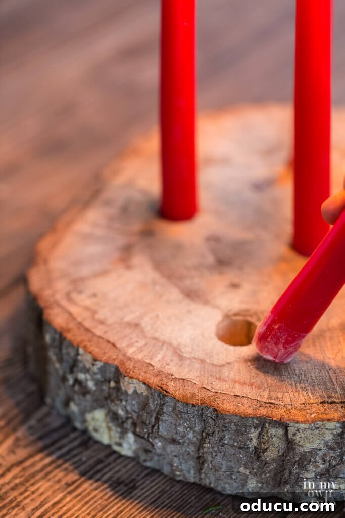 Effortless Christmas Table Wreath Crafts 12 How to place a candle in a drilled hole to create a tree trunk candle holder.