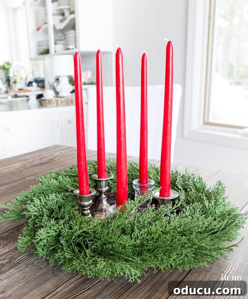 Wreath with red taper candles inside to make a centerpiece