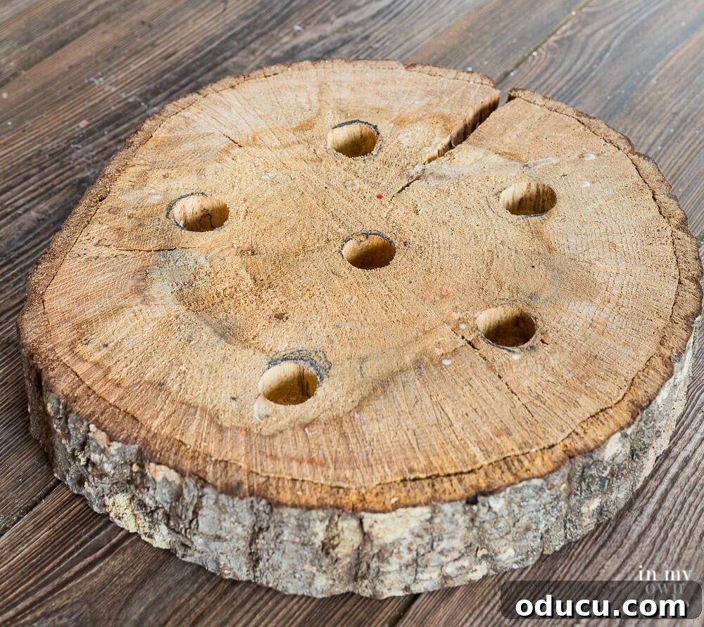Effortless Christmas Table Wreath Crafts 10 Tree trunk slice with holes drilled in for taper candles.