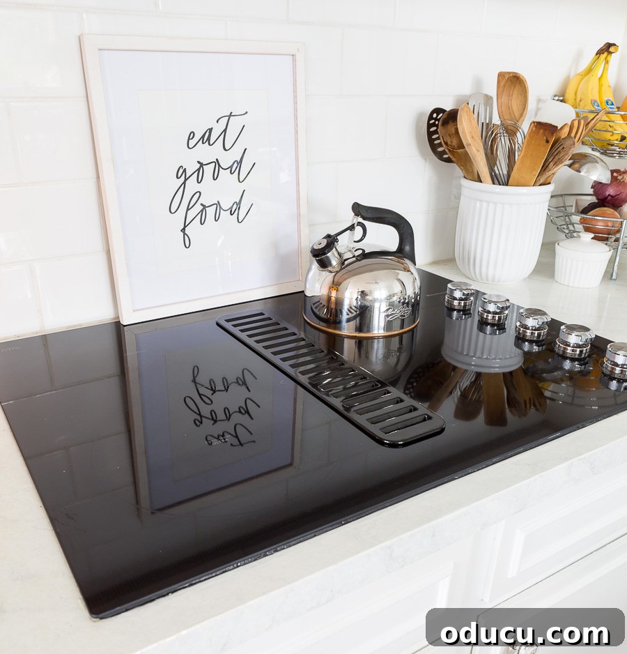 My Personal Weight Loss Victory 5 New black ceramic cooktop in white kitchen. Art leaning against back splash that says, Eat Good Food
