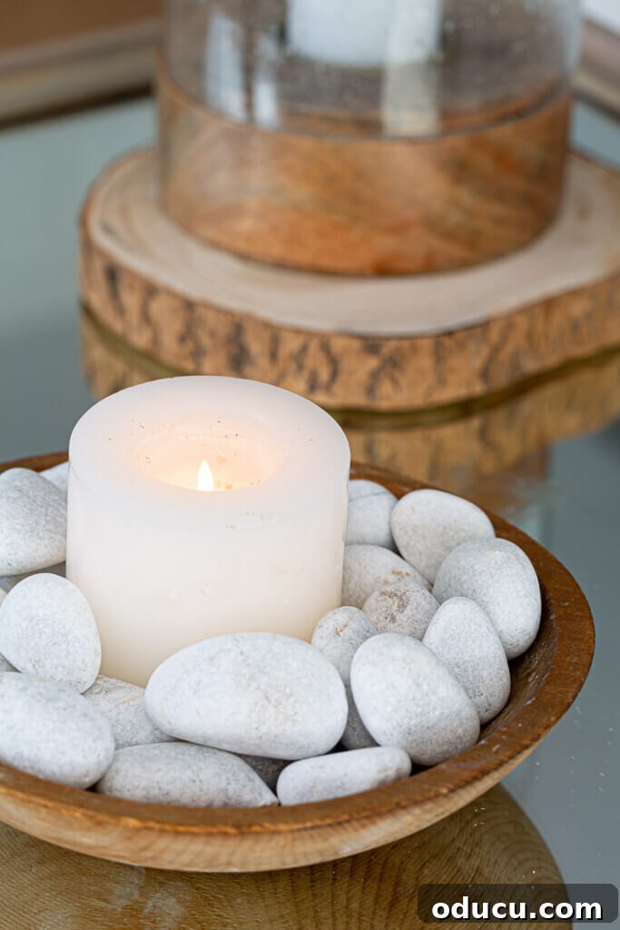 Cozy Winter Decor Beyond the Holidays 9 Winter Decorating Ideas for tables. Rocks in bowls with a candle, creating a natural centerpiece.