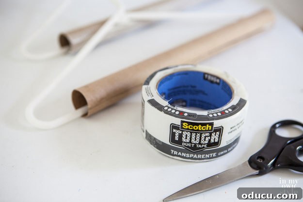 Brilliant DIY Strategies for a Perfectly Organized Home 6 Securing a cut cardboard tube with duct tape for tablecloth storage.