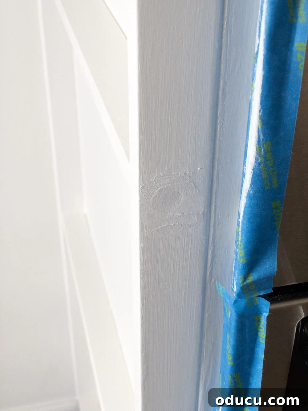 DIY Floor-to-Ceiling Wall Plate Rack 15 Applying spackle to wood screw holes on a newly built plate rack frame.