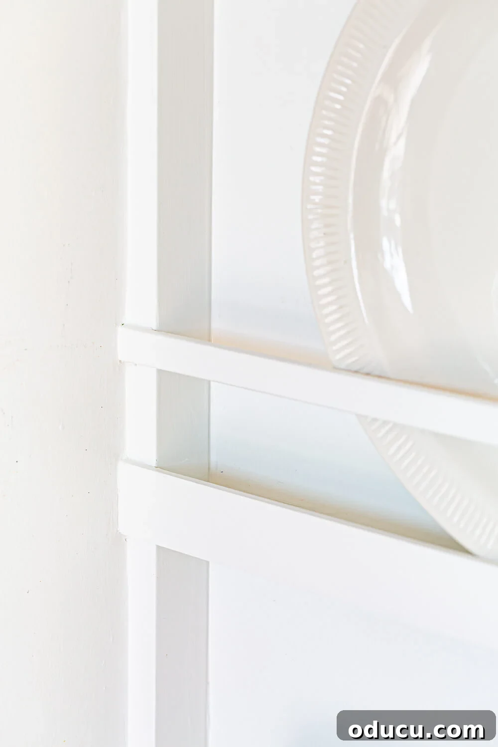 DIY Floor-to-Ceiling Wall Plate Rack 19 Placement of wood guard and safety rail on a custom-built plate rack.