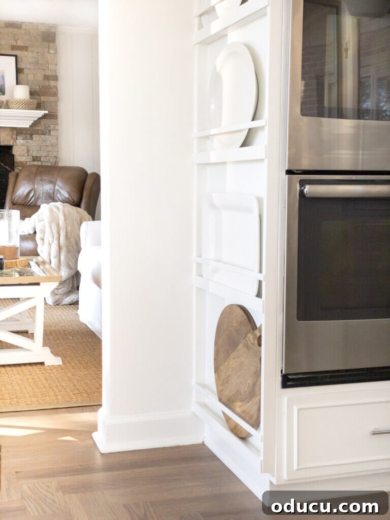 DIY Floor-to-Ceiling Wall Plate Rack 21 Completed built-in platter and plate rack showcasing white dishes on a kitchen wall.