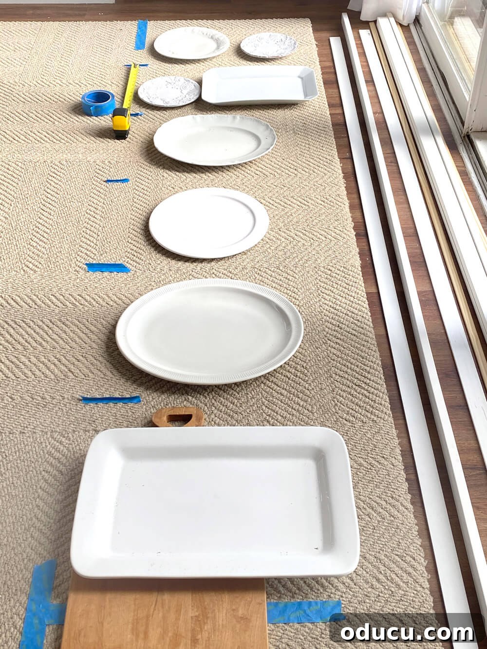 DIY Floor-to-Ceiling Wall Plate Rack 6 Layout plates on the floor to visualize spacing for a custom wall plate rack.
