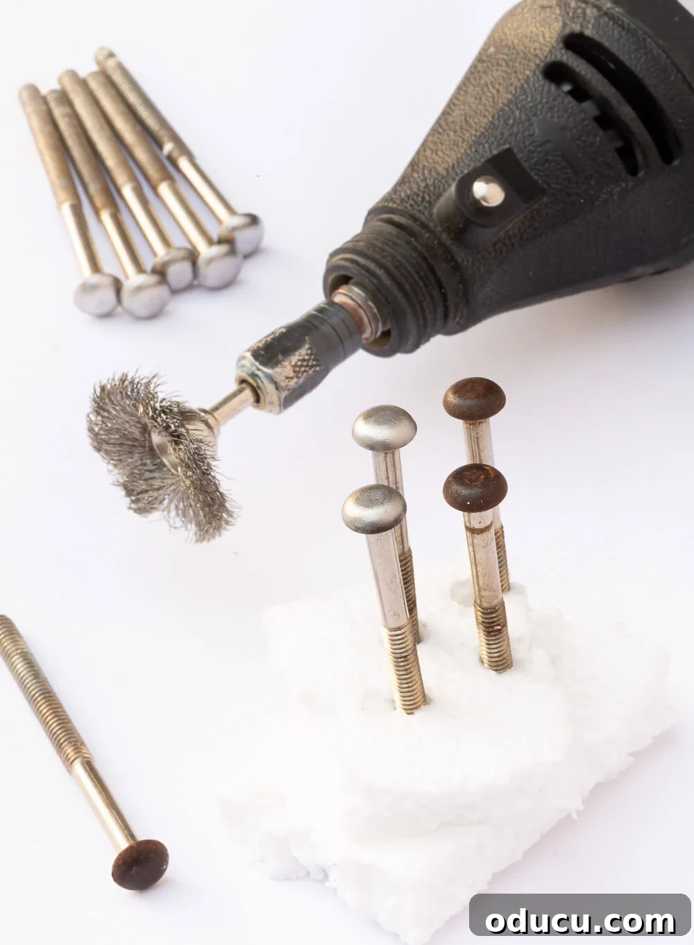 Textured Drawer Bedside Table Revamp 14 Dremel Mulit-Use tool wire brush to remove aged rust on drawer knob screws.