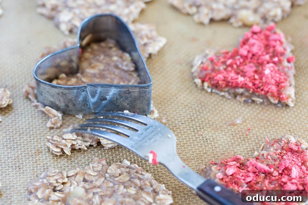 Wholesome Vegan Banana Oat Delights 13 Using a heart-shaped cookie cutter to meticulously prepare healthy Valentine's Day cookies, ensuring perfect shapes.