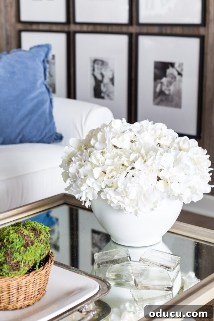The Evolution of My Living Room Style 35 White spray painted planter filled with white hydrangeas on coffee table
